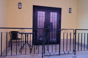 a table and chairs in front of a door at Adorable Arouca 1BDR Apartment in Arouca
