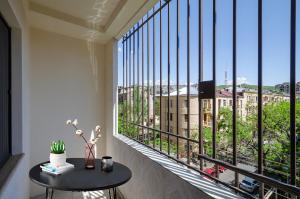 a balcony with a table and a view of a city at 5A beautiful apartment in the center of the capital photo original in Yerevan