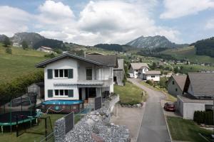 a house with a swimming pool in the yard at Haus Gmür 2 Privatzimmer - mit Gemeinschaftsbereichen in Amden