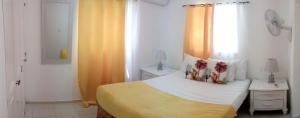 Una cama o camas en una habitación de Hostal Palmas De Punta Cana