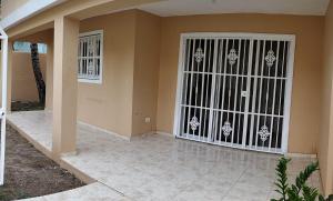 a front door of a home with a gate at Hostal Palmas De Punta Cana in Punta Cana