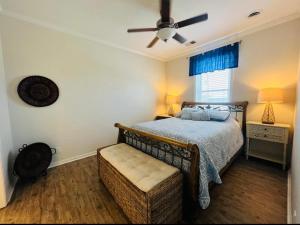 a bedroom with a bed and a ceiling fan at Beautiful Pensacola beach house in Pensacola Beach
