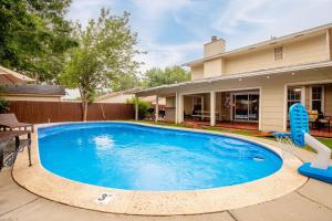 a swimming pool in front of a house at Spacious 4 bedroom with pool-Minutes to Seaworld! in San Antonio