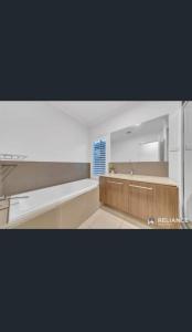 a kitchen with a sink and a counter top at Home away from Home 22 mins from Airport and CBD in Truganina