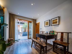 a dining room with a wooden table and benches at Xi'an Simple Palace in Xi'an +26 photos