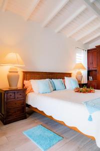 a bedroom with two beds and two lamps on a table at La Source Guest House in Orient Bay +65 photos