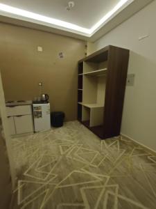 a room with a kitchen with a counter and a refrigerator at Maro Hotel in Abha