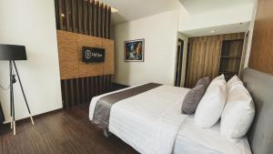 Postel nebo postele na pokoji v ubytování LPP Garden Hotel