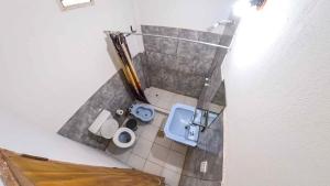 an overhead view of a small bathroom with a toilet at Hotel One 