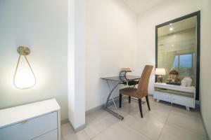a room with a desk and a table with a mirror at Alsava Villa and Suites Canggu in Canggu