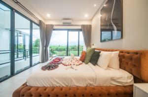 a bedroom with a large bed with a large window at Alsava Villa and Suites Canggu in Canggu