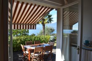 a dining room with a table and chairs on a patio at Casa Vacanze Mazurine10 in Torri del Benaco