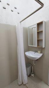 W łazience znajduje się umywalka i lustro. w obiekcie Anteng Villa 
