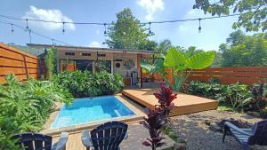 a backyard with a swimming pool and a house at Anteng Villa in Bojong