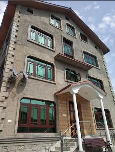 a building with many windows on the side of it at Al-Bilad Guest House in Srinagar