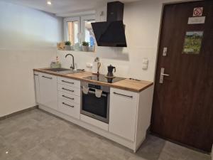 a kitchen with a sink and a stove at Wilkiejmy wieś in Jeziorany