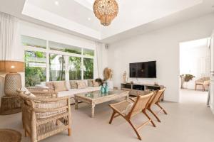 a living room with a couch and a table at Luxury Villa MISS KOH Bophut in Koh Samui 