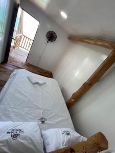 un letto bianco in una stanza con finestra di Venido Del Mar. Neymar a Barú