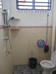 y baño con aseo, ventana y ducha. en ankang, en Alor Setar