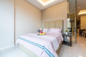 a bedroom with a large bed with a stuffed animal on it at Dorsett Residences Sri Hartamas (Kuala Lumpur) in Kuala Lumpur +42 photos