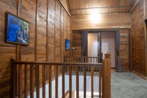 a room with wood paneled walls and a stairway at Villa Pande Buyan in Bedugul