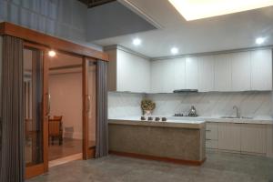 a large kitchen with a sink and a counter at Villa Pande Buyan in Bedugul