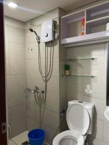 a bathroom with a shower with a toilet and a sink at condotel anuva in Manila