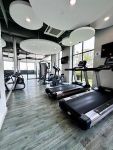 a gym with several treadmills and elliptical machines at Jazz Suites Seaview with Bathtub - 2901 in Tanjong Tokong