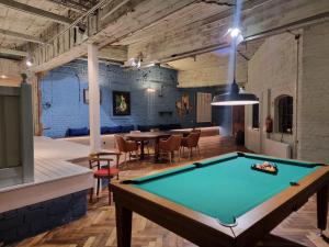 a pool table in the middle of a room with a table at Pension Zum grünen Kakadu in Göhren