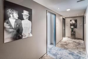 a hallway with a picture of two men on the wall at Hotel du Nord in Hamburg