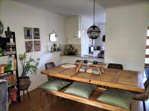 a dining room table with green cushions in a room at All the comforts by the lake in Perth