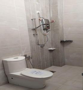 a bathroom with a toilet and a shower at Family Homstay kulim Hitech in Kampong Sira