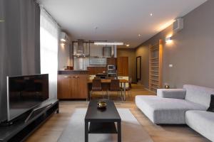 a living room with a couch and a table at Laurinska modern apartment in direct centrum of Bratislava, Air-condition in Bratislava