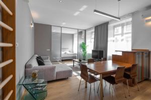 a living room with a couch and a table at Laurinska modern apartment in direct centrum of Bratislava, Air-condition in Bratislava