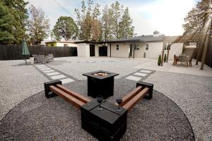 a backyard with a bench and a fire pit at The White House-NEWLY REMODELED & CENTRALLY LOCATED! in Albuquerque