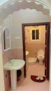 a bathroom with a sink and a toilet at شاليهات الساحل الغربي in Yanbu Al Bahr