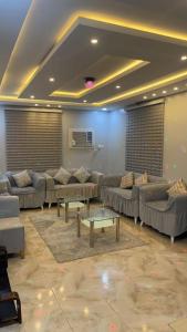 una sala de estar con sofás y mesas. en شاليهات الساحل الغربي en Yanbu Al Bahr