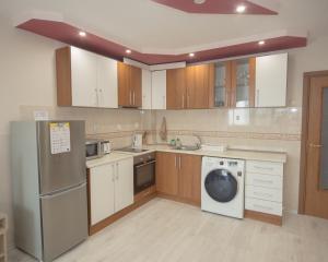 a kitchen with a washer and a dishwasher at Aleksapart in Burgas City +24 photos