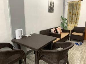 a dining room with a table and chairs at Romblon Transient House 2nd Floor in Romblon