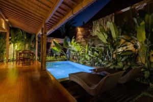 - une piscine au milieu d'une pièce ornée de plantes dans l'établissement The Ulon Ubud Villa, à Ubud