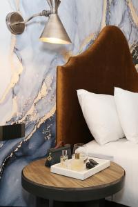 a table with a tray of food on top of a bed at Lake Jindabyne Hotel in Jindabyne