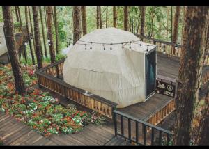 a yurt with a television on a wooden deck at Lavender Dalat Hotel and Resorts in Da Lat