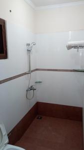 a bathroom with a shower and a toilet at Elim Homestay Fort Kochi in Cochin