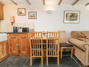 a kitchen with a table and chairs and a couch at Mole Cottage in Liskeard