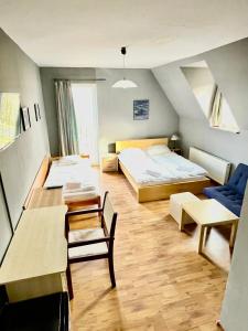 a bedroom with two beds and a table and chairs at Orlik by Good Spot in Duszniki Zdrój