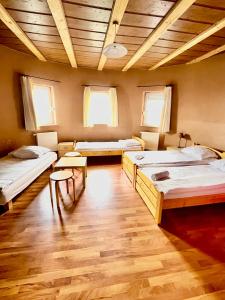a room with three beds and a wooden ceiling at Orlik by Good Spot in Duszniki Zdrój