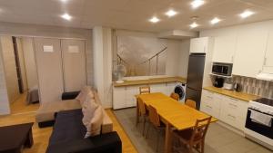 a kitchen with a table and a dining room at Saimaa Apartment in Lappeenranta