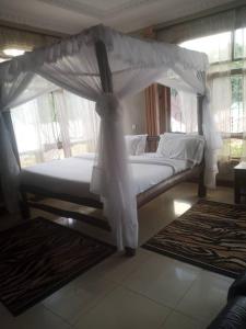 A bed or beds in a room at The Leopold Machakosi