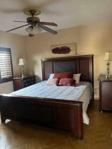 a bedroom with a large bed with a ceiling fan at Casa Maya in Mexicali