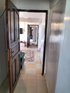 a hallway with an open door to a room at Olympic Lamu sea front house - 2 bedroom All ensuite in Lamu